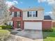 Charming two-story home with brick and siding and an attached two-car garage at 10303 Memorial Knoll Dr, Indianapolis, IN 46234