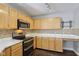 Kitchen with stainless appliances, white countertops and maple cabinets with stylish lighting at 10303 Memorial Knoll Dr, Indianapolis, IN 46234