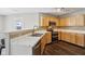 Kitchen with stainless appliances, white countertops, double sink and light maple cabinets with door to back yard at 10303 Memorial Knoll Dr, Indianapolis, IN 46234