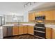 Well-equipped kitchen featuring stainless steel appliances, light wood cabinets, and quartz countertops at 10303 Memorial Knoll Dr, Indianapolis, IN 46234