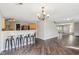 Bright and open living space with hardwood floors, a breakfast bar and easy access to the staircase at 10303 Memorial Knoll Dr, Indianapolis, IN 46234