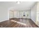 Open-concept living room with wood floors, natural light and entryway to the home at 10303 Memorial Knoll Dr, Indianapolis, IN 46234