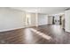 Expansive living room featuring dark wood flooring, neutral walls, and ample natural light at 10303 Memorial Knoll Dr, Indianapolis, IN 46234