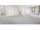 Open living room with carpet, natural light, and hallway access at 10303 Memorial Knoll Dr, Indianapolis, IN 46234