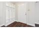 Entryway with a white door, coat rack, and wood-style floors, creating a welcoming space at 10303 Memorial Knoll Dr, Indianapolis, IN 46234