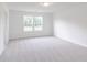 Large bedroom with neutral colored carpet, light walls, and two windows providing plenty of natural light at 1038 Stubble Run, Danville, IN 46122