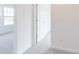 Carpeted hallway showcasing natural light from an adjacent room at 1038 Stubble Run, Danville, IN 46122
