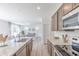 Open-concept kitchen with stainless appliances and wood-look floors at 1038 Stubble Run, Danville, IN 46122