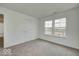 Carpeted bedroom featuring a door, windows and neutral walls at 1056 Stubble Run, Danville, IN 46122