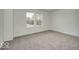 Carpeted bedroom with a natural view from the two large windows at 1056 Stubble Run, Danville, IN 46122