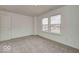 Carpeted bedroom with neutral walls and two windows for natural light at 1056 Stubble Run, Danville, IN 46122