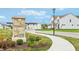 Inviting community entrance sign with stone base and well-maintained landscaping in front of newer homes at 1056 Stubble Run, Danville, IN 46122