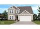 Charming two-story home features a neutral color, a two-car garage, and a well-maintained lawn at 1056 Stubble Run, Danville, IN 46122