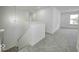 Bright hallway with carpeted floors, stairs, chandelier, and natural light at 1056 Stubble Run, Danville, IN 46122