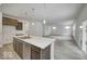 Modern kitchen with stainless steel appliances and a center island that flows into a cozy living area at 1056 Stubble Run, Danville, IN 46122