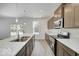 Modern kitchen with stainless steel appliances, granite countertops, and wood cabinets near sliding door at 1056 Stubble Run, Danville, IN 46122