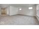 Spacious living room features neutral walls, plush carpet, and multiple windows allowing natural light at 1056 Stubble Run, Danville, IN 46122