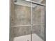 Bathroom featuring shower with gray tile walls and a sliding glass door with silver trim at 1056 Stubble Run, Danville, IN 46122