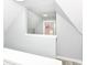 View of the attic with white walls, vinyl floors, and natural light coming from the window at 121 Illinois St, Shirley, IN 47384