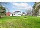 Expansive backyard features a lush lawn and mature trees, creating a private and serene outdoor space at 121 Illinois St, Shirley, IN 47384