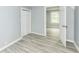 Bedroom featuring vinyl floors, gray paint, closet and an open doorway to another room at 121 Illinois St, Shirley, IN 47384