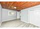 Bedroom showcasing wood plank ceiling, gray walls, vinyl floors, closet, and natural light at 121 Illinois St, Shirley, IN 47384