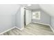 Bedroom featuring vaulted ceiling, gray walls, vinyl floor, a closet, and natural light at 121 Illinois St, Shirley, IN 47384