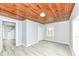Bedroom featuring wood plank ceiling, gray walls, vinyl floor, and a closet at 121 Illinois St, Shirley, IN 47384