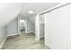 Cozy bedroom features wood-look floors, an ample closet, and an open door to the rest of the house at 121 Illinois St, Shirley, IN 47384
