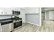 Well-equipped kitchen with stainless steel appliances, great counterspace, and bright white cabinets at 121 Illinois St, Shirley, IN 47384