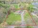Large lot featuring mature landscaping and lengthy drive outlined in red for reference at 12166 N Bray Rd, Mooresville, IN 46158