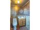 Bathroom featuring patterned wallpaper, wood paneling, and vanity at 12166 N Bray Rd, Mooresville, IN 46158