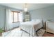 Cozy bedroom with natural light, white bedding, and hardwood floors providing a calming retreat at 12166 N Bray Rd, Mooresville, IN 46158