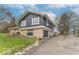 View showcasing the side of a blue and stone home featuring an attached garage and a lush yard at 12166 N Bray Rd, Mooresville, IN 46158