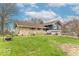Charming home featuring a stone facade, blue siding, well-manicured lawn and mature trees under a partly cloudy sky at 12166 N Bray Rd, Mooresville, IN 46158