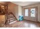 Inviting foyer with hardwood floors, decorative stairs, and a stained glass front door at 12166 N Bray Rd, Mooresville, IN 46158