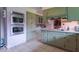 The kitchen boasts stainless steel double ovens and ample light green cabinetry, offering lots of storage at 12166 N Bray Rd, Mooresville, IN 46158