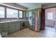 Spacious kitchen featuring stainless steel appliances, tile flooring, and light green cabinetry at 12166 N Bray Rd, Mooresville, IN 46158