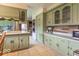 Spacious kitchen featuring tiled floors, stainless steel appliances, and ample green cabinetry for storage at 12166 N Bray Rd, Mooresville, IN 46158