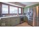 Bright kitchen featuring stainless steel appliances, including a refrigerator and dishwasher, complemented by tile floors at 12166 N Bray Rd, Mooresville, IN 46158
