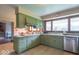 Well-lit kitchen with abundant counter space and light green cabinets, creating a warm atmosphere at 12166 N Bray Rd, Mooresville, IN 46158