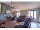 Comfortable living room featuring leather reclining chairs, stone fireplace, and natural light from multiple windows at 12166 N Bray Rd, Mooresville, IN 46158