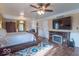 Spacious main bedroom featuring hardwood floors, a fireplace, a large TV and ample natural light at 12166 N Bray Rd, Mooresville, IN 46158