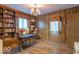 Home office featuring wood paneling, natural light, and built-in shelving for a functional workspace at 12166 N Bray Rd, Mooresville, IN 46158