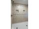 Tiled shower featuring built-in shower niche and bronze fixtures at 12166 N Bray Rd, Mooresville, IN 46158