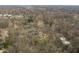 High aerial view of home nestled in mature trees among other homes in the distance in a wooded neighborhood at 123 W 81St St, Indianapolis, IN 46260