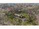 Aerial view of a modern home nestled among mature trees, showcasing its sprawling lot and serene setting at 123 W 81St St, Indianapolis, IN 46260
