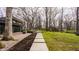 Spacious backyard with stone pathway to patio with fire pit seating and built-in grill at 123 W 81St St, Indianapolis, IN 46260
