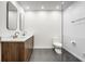 Elegant bathroom with double sinks, wood cabinetry, sleek mirrors, and a glass-enclosed shower at 123 W 81St St, Indianapolis, IN 46260
