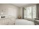 Serene Bedroom featuring a white crib, large window, and comfortable seating area at 123 W 81St St, Indianapolis, IN 46260